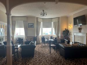 a living room with couches and chairs and a fireplace at Clifton Hotel in Scarborough +45 photos