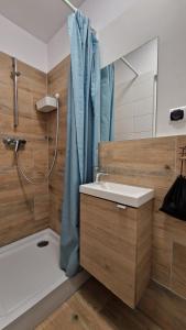 a bathroom with a sink and a tub and a shower at L&B House in Malbork +104 photos