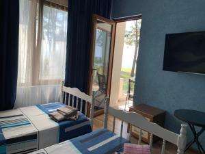 a room with two beds and a table and a window at ARGO Shekvetili in Shekhvetili