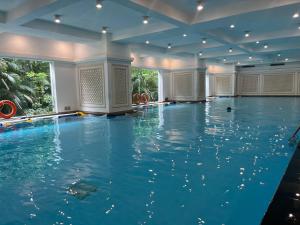an indoor swimming pool with blue water in a building at Vinhomes Royal City Luxury Apartment 2 Br in Hanoi