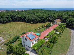 an aerial view of a house with a solar roof at Вила Сириус in Sinemorets