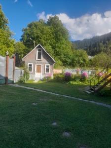 a small house in the middle of a yard at Guesthouse ''Kavkasioni'' in Glola