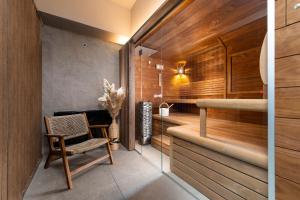 a room with a chair and a sauna at Three Corners Avenue Hotel in Budapest