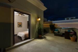 a room with a door open and a bed in it at Decanter Hotel in San Juan