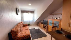 a living room with a couch and a table at Apartamento A Costa Da Morte in Santa Comba