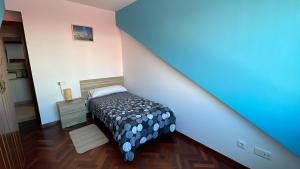 a bedroom with a bed in a small room at Apartamento A Costa Da Morte in Santa Comba