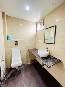 a bathroom with a sink and a toilet at METRO HOTEL Nathdwara , 500mtr 10min walking from shreenathji temple 966o9o1oo6 in Nāthdwāra