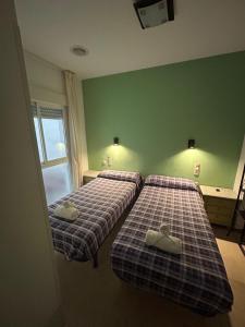 Postel nebo postele na pokoji v ubytování Hostal El Olivo