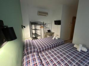 Postel nebo postele na pokoji v ubytování Hostal El Olivo