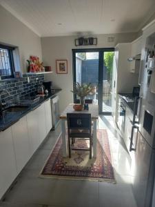 a kitchen with a table in the middle of it at Lisa's in Malmesbury