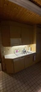 a kitchen with a sink and a tiled floor at Haus Am Teich Oetjens in Weilburg_Gaudernbach +190 photos