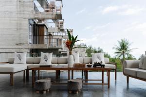 a living room with a couch and a coffee table at Varivana Resort Koh Phangan, The Centara Collection in Thong Sala