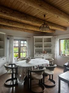 a kitchen with a table and chairs in a room at Country Chalet in Praid
