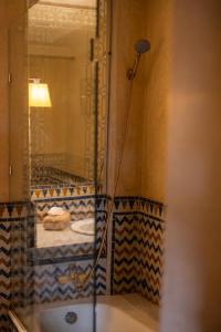 a bathroom with a mirror and a bed in a room at LUXURY apartment in Marrakesh +22 photos