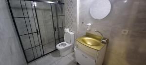 a bathroom with a toilet and a sink and a mirror at Grand Onur Hotel in Istanbul