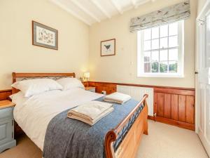 a bedroom with a bed and a window at Papist Hall Cottages in Barrow upon Humber