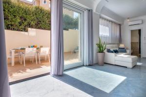 a living room with a couch and a table at LUXURY HOUSE Olbia center with private garden in Olbia