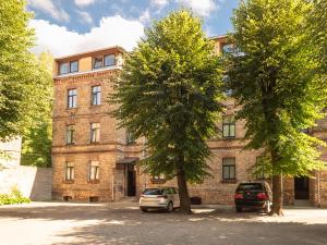 een bakstenen gebouw met twee bomen ervoor bij Midcentury modern, quiet, 40m studio with bath in Rīga