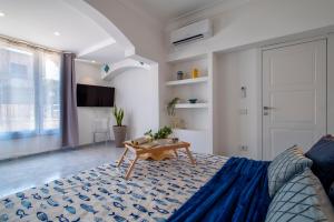 a living room with a bed and a table at LUXURY HOUSE Olbia center with private garden in Olbia