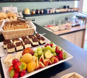 a buffet with cakes and fruit on a table at Fregata in Łeba +7 photos