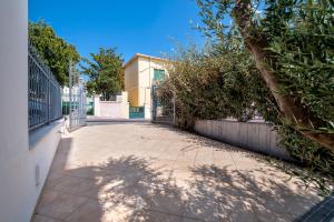 an empty sidewalk in front of a building at LUXURY HOUSE Olbia center with private garden in Olbia