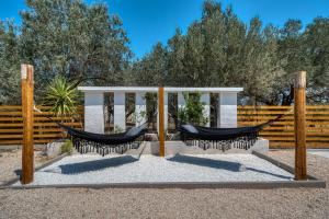 two hammocks in front of a fence at Green Poetree Houses in Galatas