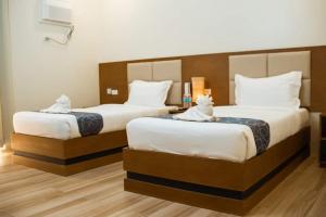 Postel nebo postele na pokoji v ubytování MDM Town Hotel
