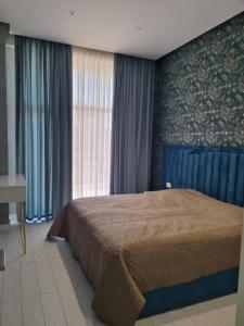 a bedroom with a large bed and a window at 2 комнатная квартира in Sumqayyt