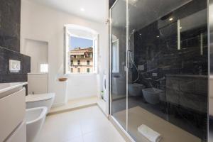 a bathroom with a glass shower and a toilet at CasaViva - Elegant Seaview Studio in Camogli in Camogli +14 photos