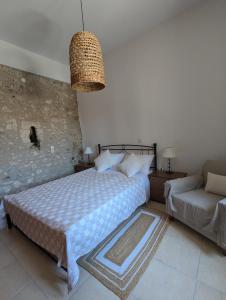 a bedroom with a bed and a couch at Casa Leone, whole house with private pool! in Atsipopoulo