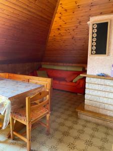 a room with a bed and a table in a cabin at La piccola Baita in Folignano