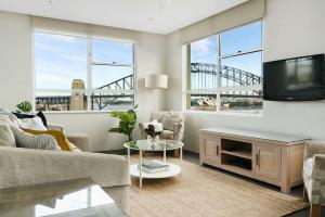 a living room with a couch and a tv at Harbourside #76 in Sydney