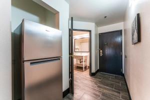 a kitchen with a stainless steel refrigerator in a room at Metro Tempe Extended Stay - 2 Full Beds in Tempe