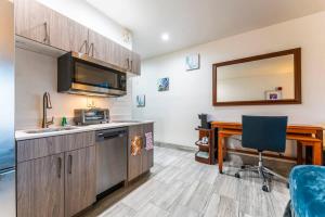 a kitchen with a sink and a desk with a chair at Metro Tempe Extended Stay - 2 Full Beds in Tempe