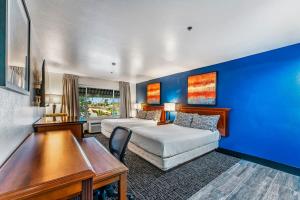 a hotel room with two beds and a desk at Metro Extended Stays - Tempe - 2 Full Beds in Tempe