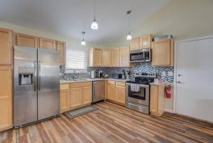 a kitchen with stainless steel appliances and wooden cabinets at Spacious 4BD Dog-friendly Home near USAF Academy in Colorado Springs