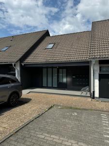 a house with a car parked in front of it at FeWo Capreolus in Winterberg