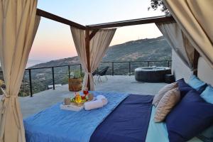 a bed in a tent with a view of the ocean at Star Sleep Rodakino in Rethymno