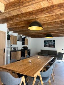 a dining room with a wooden table and chairs at Gîte de Condeiss in Condeissiat +8 photos