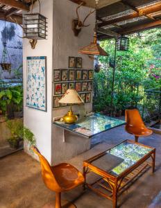 a living room with a glass table and chairs at Kandy Inn Madugalle’s family guest house in Kandy