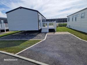 a large metal building sitting next to a building at Beechwood 20 in Camber
