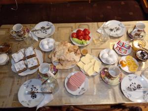 a table topped with plates and bowls of food at Guest house gegi aprasidze in Soli