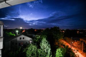 a view of a city at night with a building at Dracevo Apartments with Free Parking in Dračevo