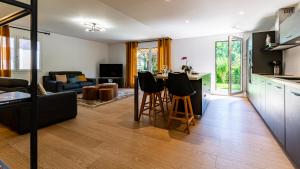 a kitchen and living room with a table and chairs at La Cerisaie in Talant