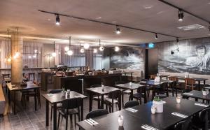 a restaurant with tables and chairs in a room at Skuggi Hotel by Keahotels in Reykjavík