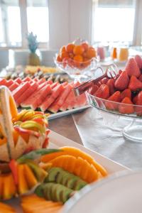 a buffet of fruits and vegetables on a table at Rouge International Resort in Milano Marittima