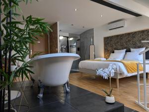 a bedroom with a bed and a bath tub in it at La Suite - Villa Valmy - Hypercentre - Gare SNCF in Montluçon
