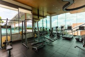 a gym with a lot of treadmills and machines at Cozy room near Night bazaar in Chiang Mai