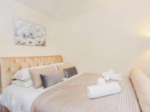 a bedroom with a large bed with white sheets and pillows at Barn near york with hot tub in York