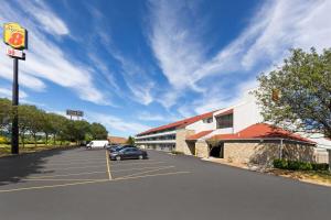 a car parked in a parking lot next to a building at Super 8 by Wyndham Fort Mitchell Cincinnati Area in Fort Mitchell